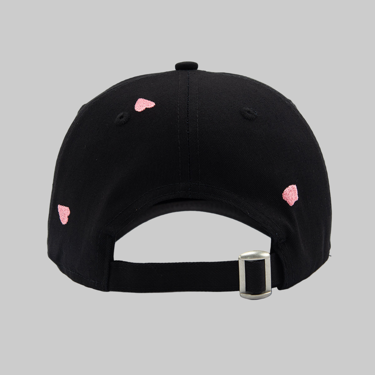 Black cap with pink sakura petals shapes on a white background