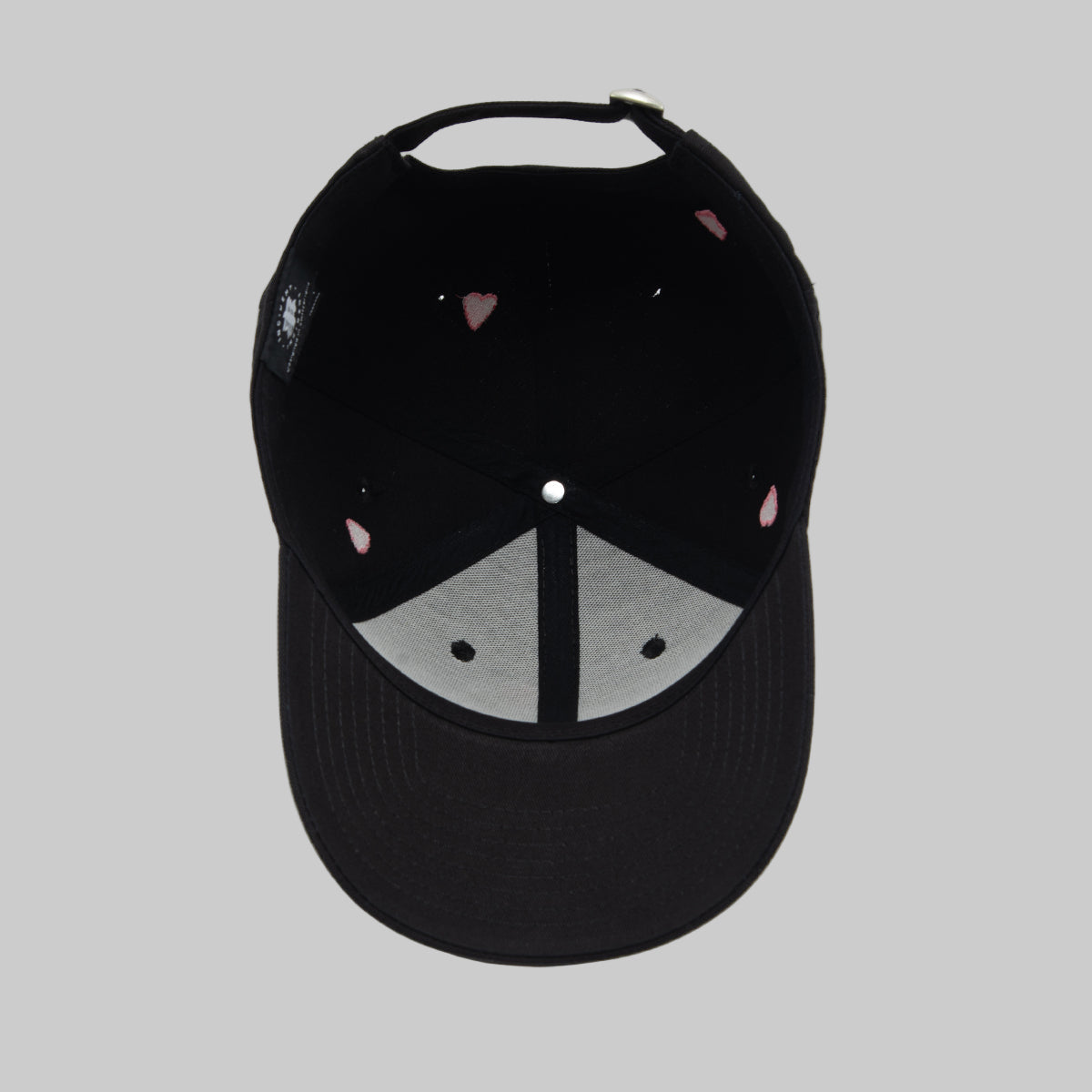 Black cap with a peace symbol design on a white background