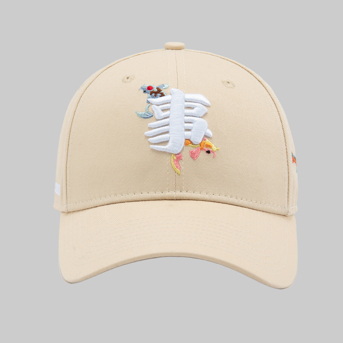 Beige cap with embroidered design on a white background