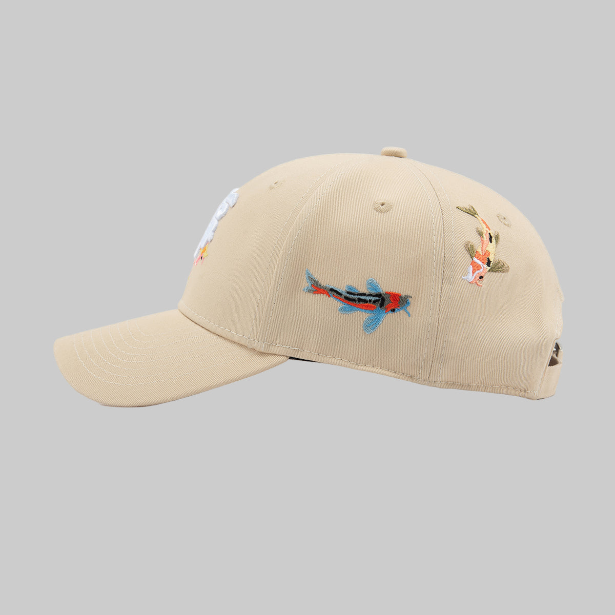 Beige cap with embroidered designs on a white background