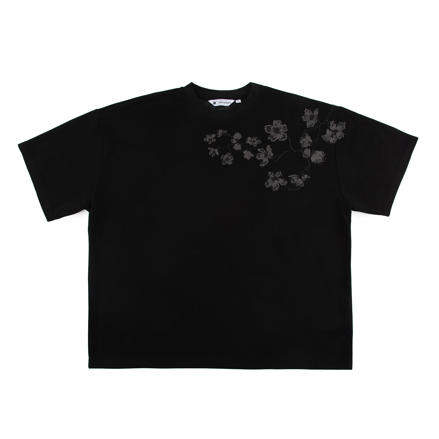 Black t-shirt with embroidered floral design on a white background