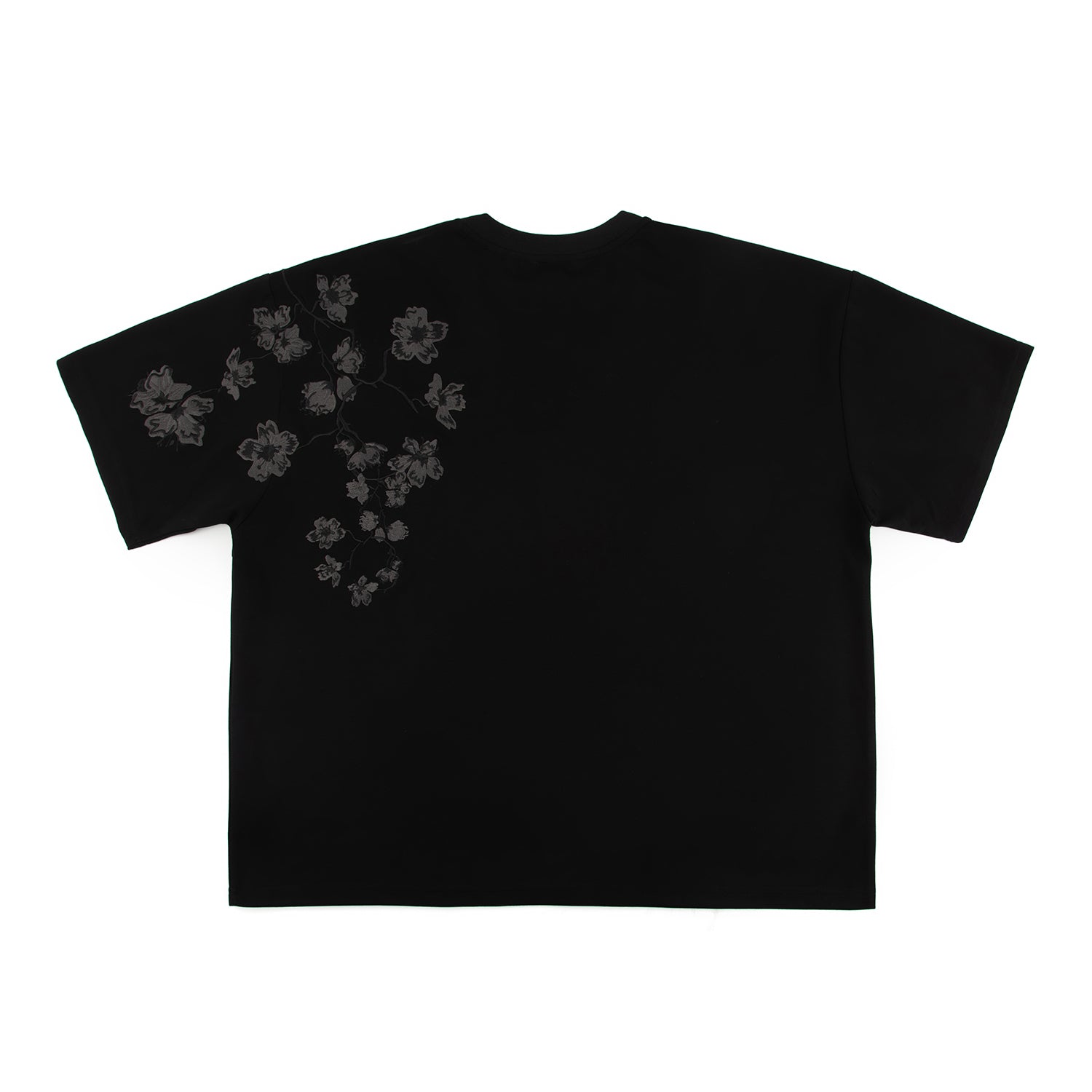 Black t-shirt with embroidered floral design on a white background