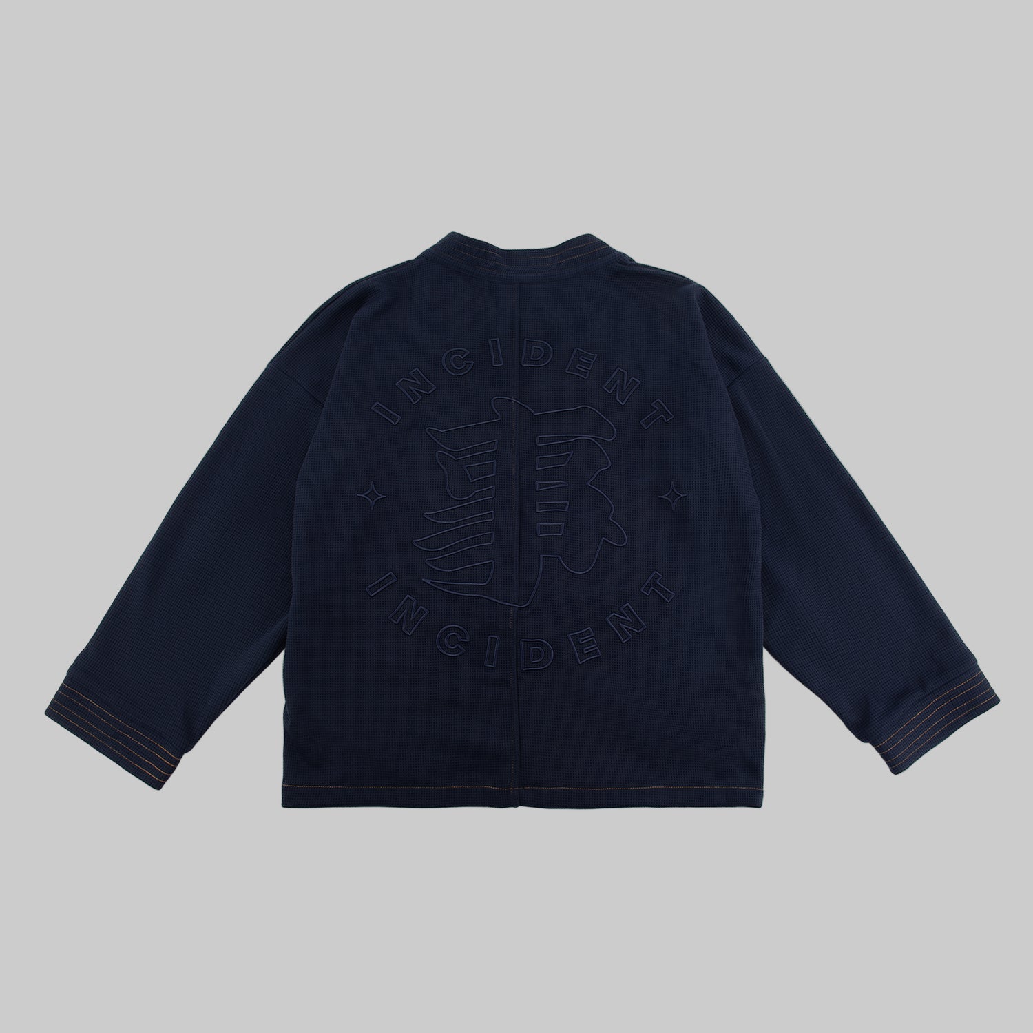 Navy blue jacket with text on the back against a white background
