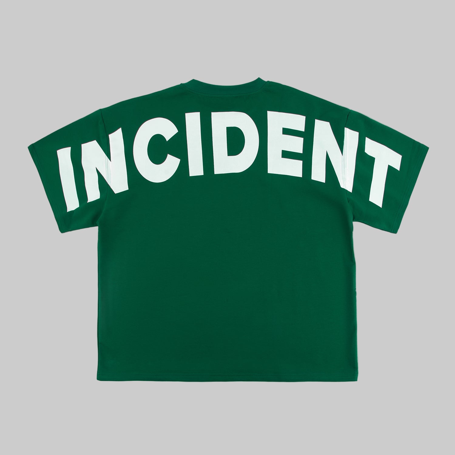 Green t-shirt with 'INCIDENT' printed on the back against a white background