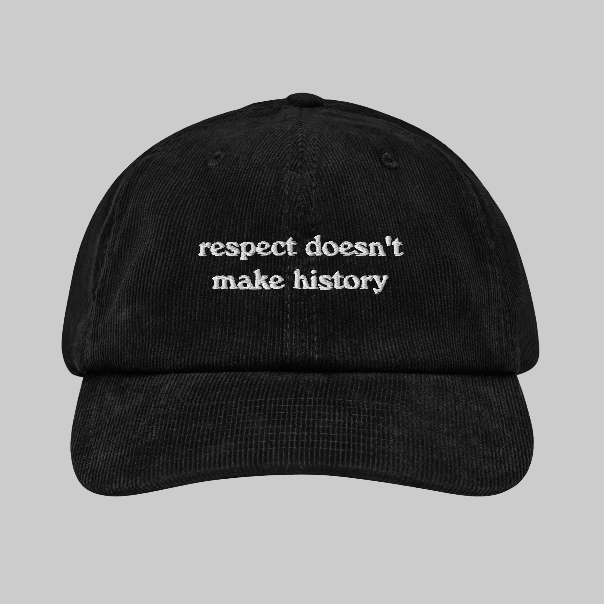 A black corduroy 6-panel cap with an adjustable strap and a white text on the front that reads 'respect doesn't make history'.