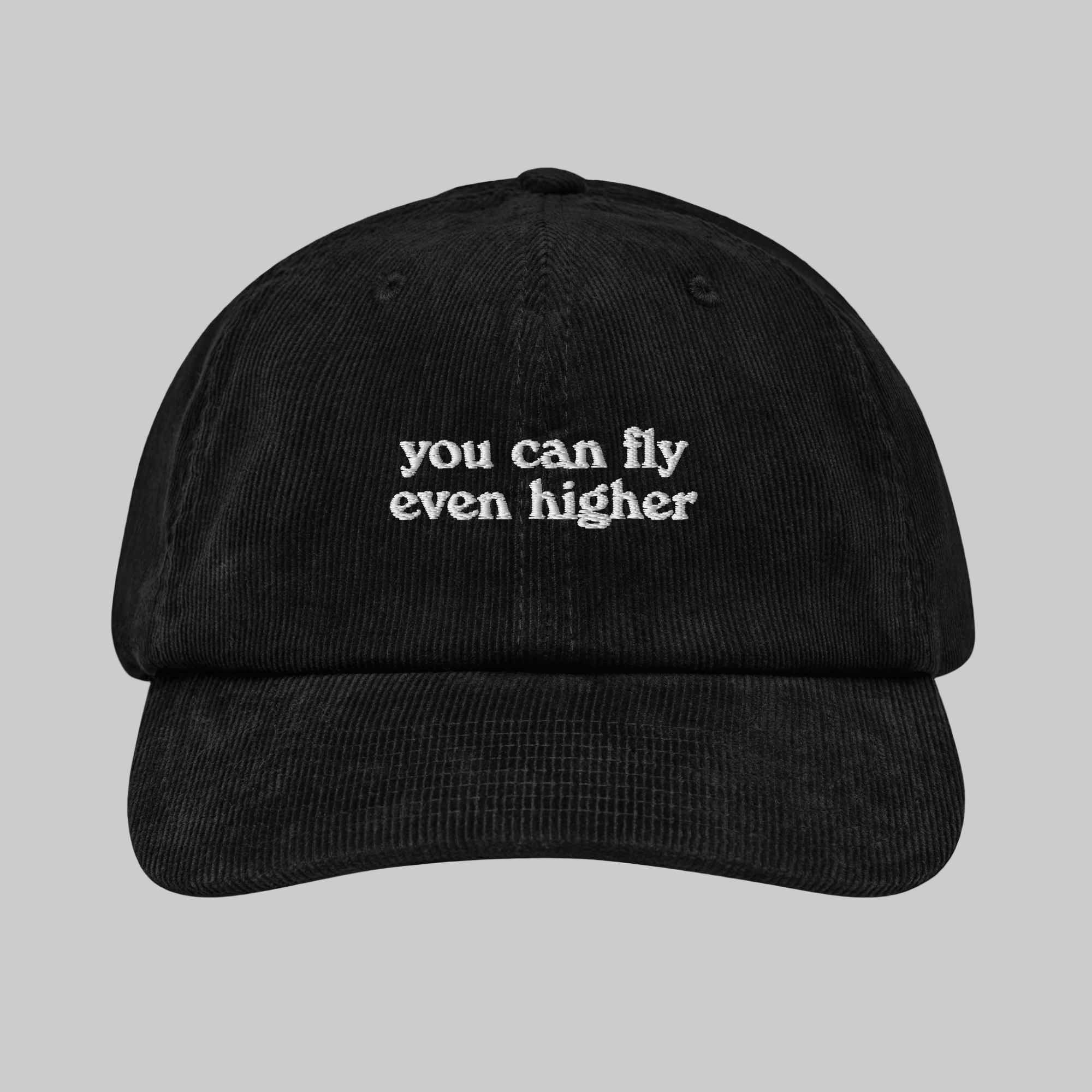 Black corduroy hat with the text 'You can fly even higher' printed on the front panel.