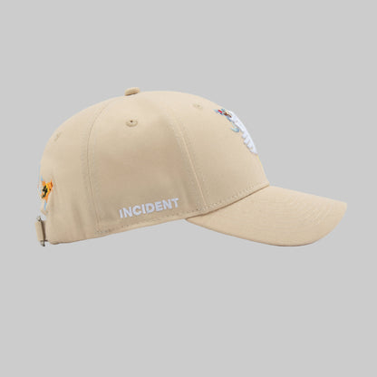 Beige cap with 'INCIDENT' branding on a white background