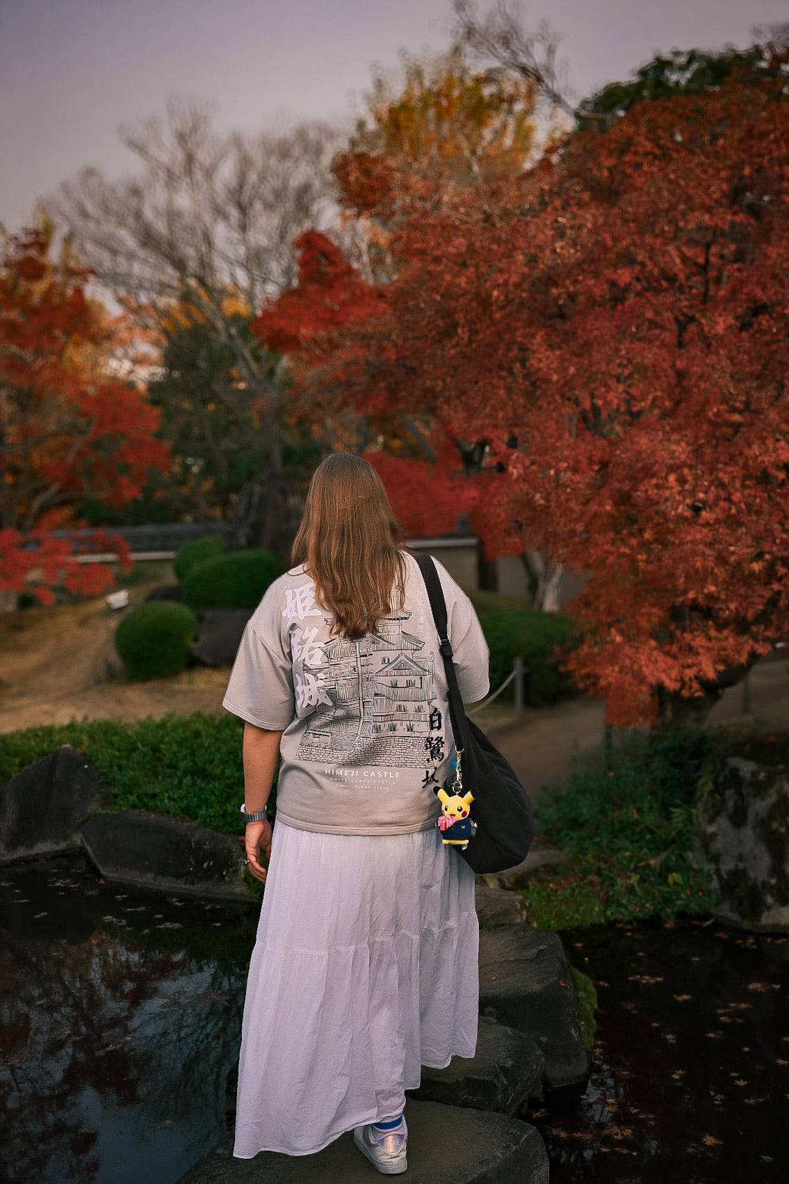 Woman walking in a park with autumn foliage
