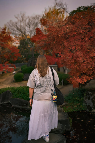 Woman walking in a park with autumn foliage