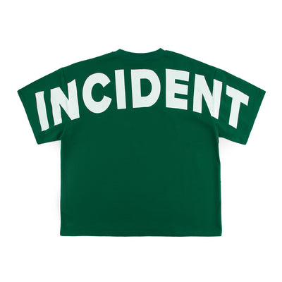 Green t-shirt with 'INCIDENT' printed on the back against a white background